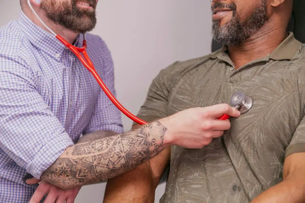 Primary care provider listing to a patients heart and lungs